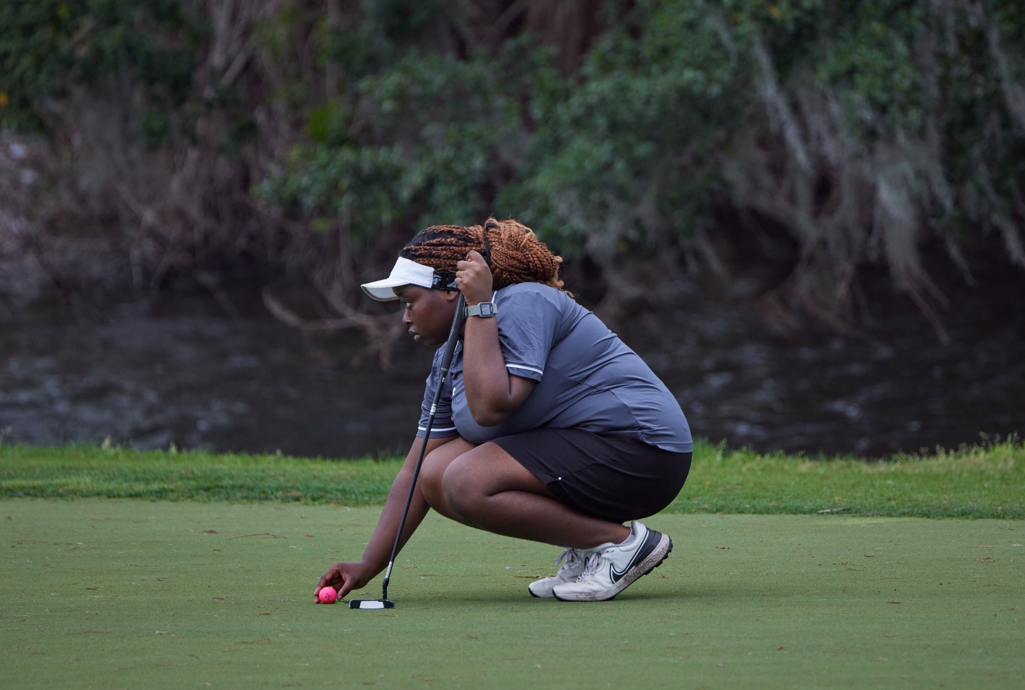 A player studying her next putt