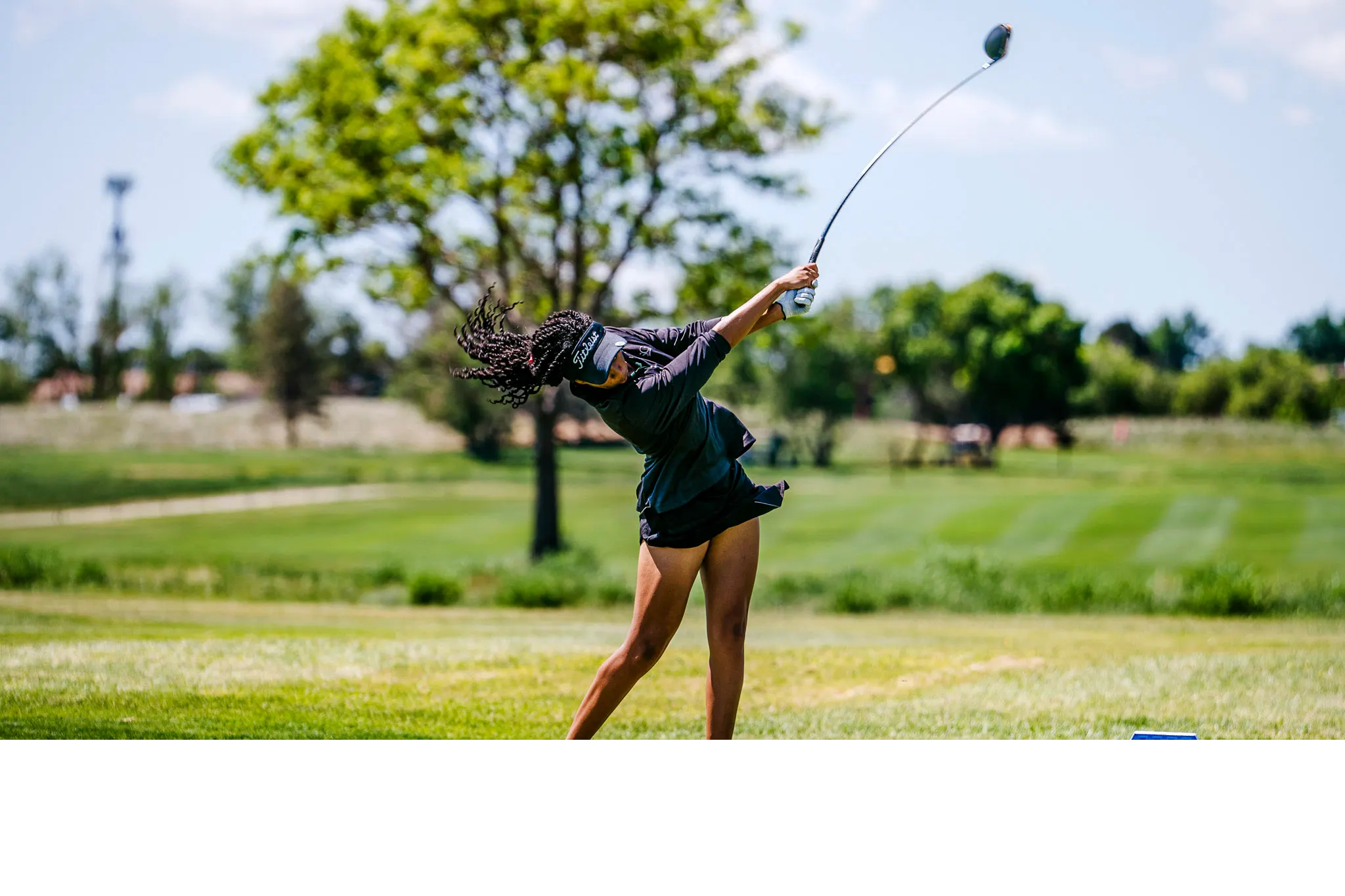 Amateur golfer Genesis Lewis swinging on the course