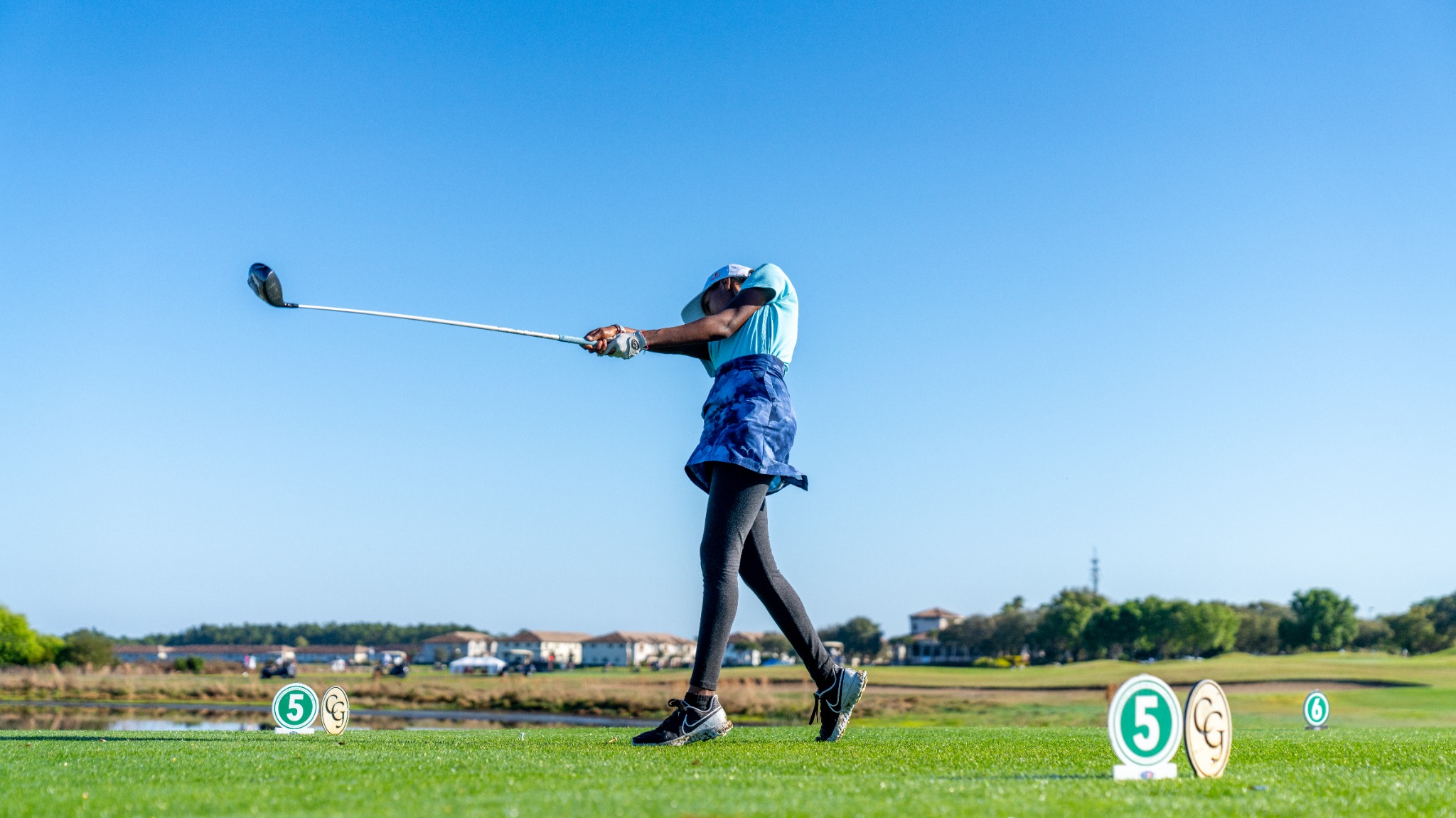 A golfer practicing on the course