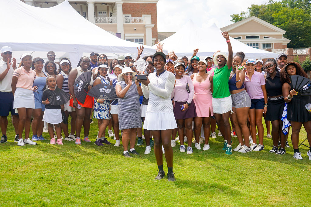 Sapphire Golf Tour champion holding her trophy with players and supporters